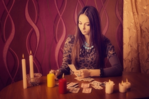 71067075 - young woman with divination cards in room
