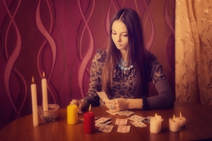 71067075 - young woman with divination cards in room